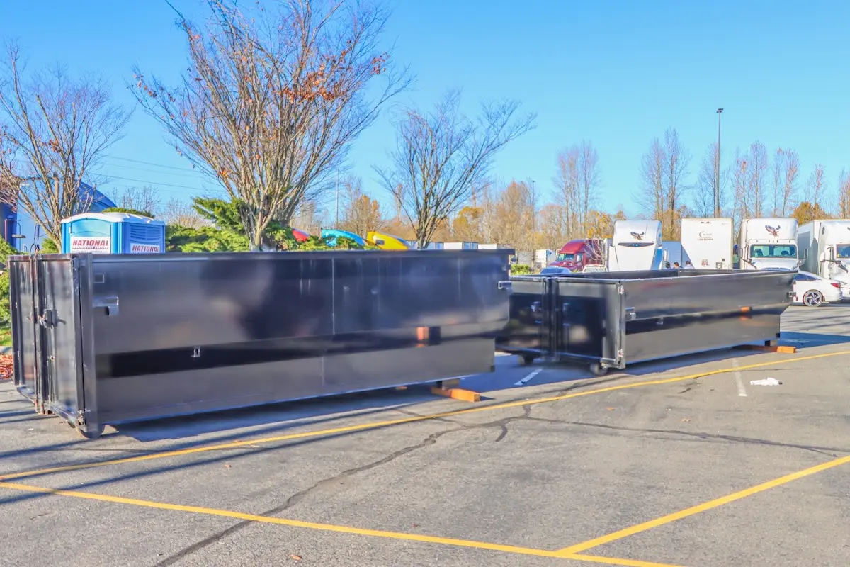 Professional dumpster rental service with roll-off container on residential driveway in Memphis